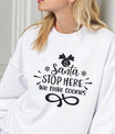 White sweatshirt with black “Santa Stop Here We Have Cookies” DTF design featuring snowflakes and an ornament.