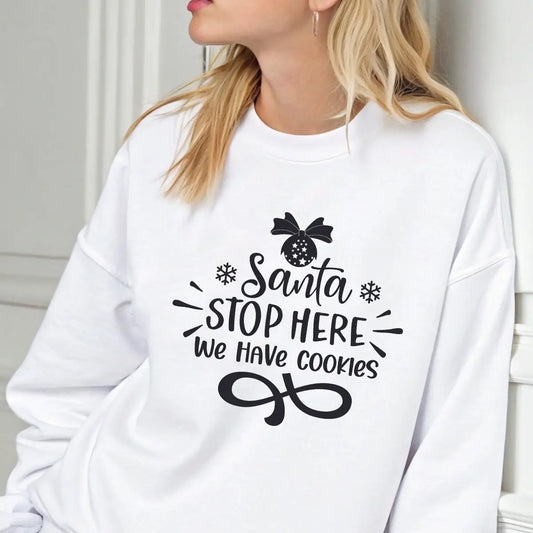White sweatshirt with black “Santa Stop Here We Have Cookies” DTF design featuring snowflakes and an ornament.