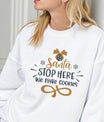 White sweatshirt with “Santa Stop Here We Have Cookies” DTF design in gold and black featuring an ornament and snowflakes.