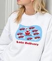 White sweatshirt featuring “Late Delivery” DTF design with Santa stuck in traffic surrounded by red cars, funny Christmas shirt design.