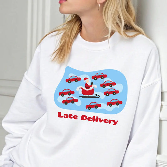 White sweatshirt featuring “Late Delivery” DTF design with Santa stuck in traffic surrounded by red cars, funny Christmas shirt design.
