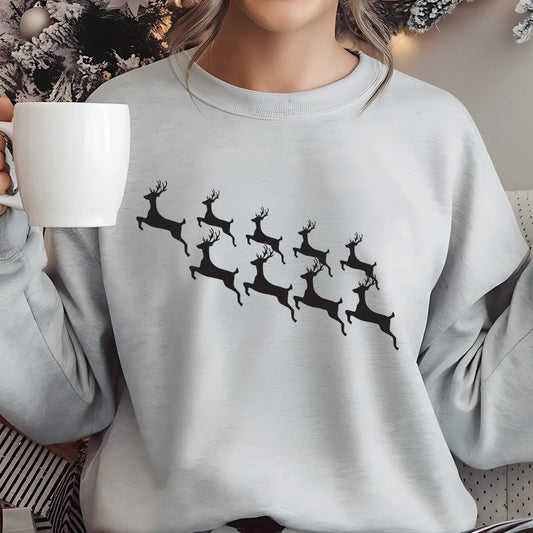Grey sweatshirt featuring minimalist black reindeer silhouettes in flight, simple and elegant Christmas DTF transfer design.