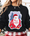 Black sweatshirt featuring a colorful Santa design with trees, snow, and ornaments and “Merry Christmas” text – festive DTF transfer design.