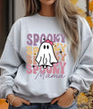 Light gray sweatshirt with a cute ghost wearing a pink bow and the words “Spooky Mama” in retro pastel colors, perfect for Halloween moms.