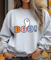Gray sweatshirt with colorful “BOO!” Halloween DTF transfer design featuring a cute white ghost popping out of the letter O.