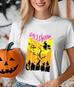 White T-shirt with bright orange and yellow Halloween DTF transfer featuring a witch flying over a graveyard and pink Halloween text.