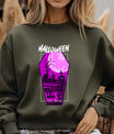 Green sweatshirt featuring a purple coffin-shaped Halloween DTF design with tombstones, zombies, trees, and full moon graphic.