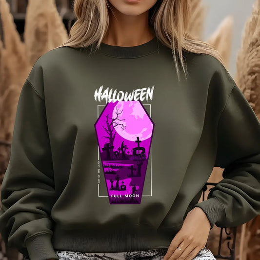 Green sweatshirt featuring a purple coffin-shaped Halloween DTF design with tombstones, zombies, trees, and full moon graphic.