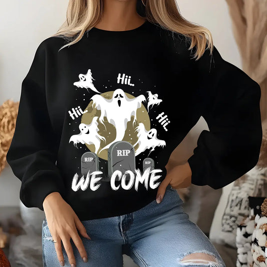Black sweatshirt featuring “We Come” Halloween DTF design with glowing ghosts, gravestones, and a moon background.