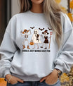 Grey sweatshirt with “Ghouls Just Wanna Have Fun” DTF transfer featuring dancing skeletons, ghost, and bats in a cute Halloween design.