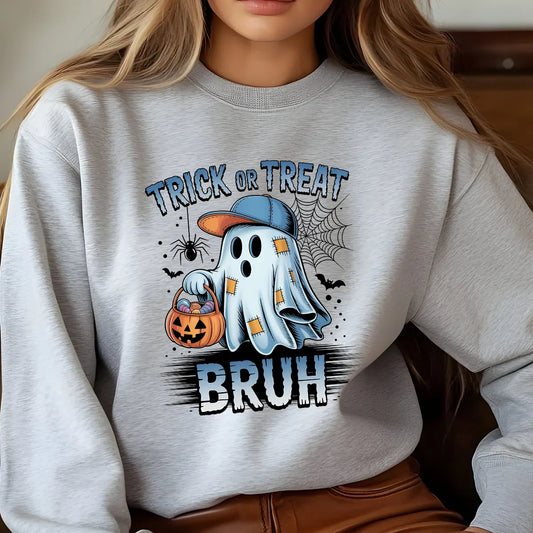 Gray sweatshirt with “Trick or Treat Bruh” DTF transfer showing a cartoon ghost wearing a cap and holding a pumpkin bucket with candies in a Halloween design.