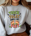 Gray sweatshirt with “Trick or Treat Smell My Feet” DTF transfer design featuring cartoon feet, bats, and cobwebs in Halloween colors.