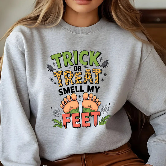 Gray sweatshirt with “Trick or Treat Smell My Feet” DTF transfer design featuring cartoon feet, bats, and cobwebs in Halloween colors.