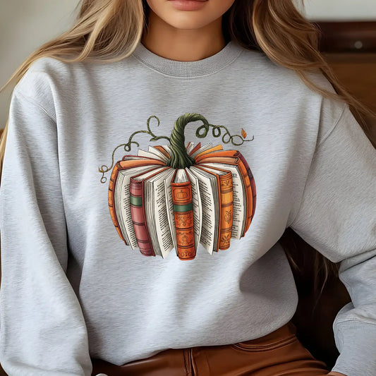 Gray sweatshirt with a pumpkin made of stacked books and green vines, cozy fall DTF transfer design for book lovers.