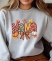 Gray sweatshirt with colorful “MAMA” fall design featuring pumpkins, leaves, and a bow, cozy autumn DTF transfer.