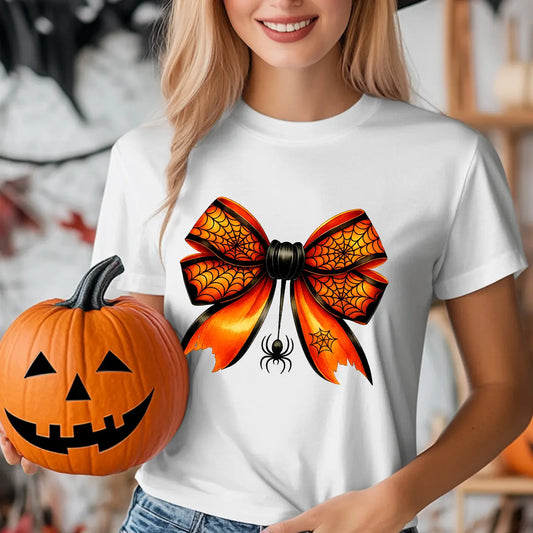 White t-shirt with orange and black spiderweb bow design featuring a hanging spider, perfect for Halloween-themed outfits.