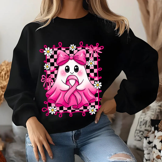 Black sweatshirt featuring a cute ghost holding a pink ribbon, surrounded by daisies and bows in a pink checkered frame for breast cancer awareness.