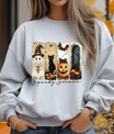 Grey sweatshirt featuring a Halloween-themed DTF transfer with a ghost, black cat, pumpkin, bat, and “Spooky Season” text in warm fall colors.
