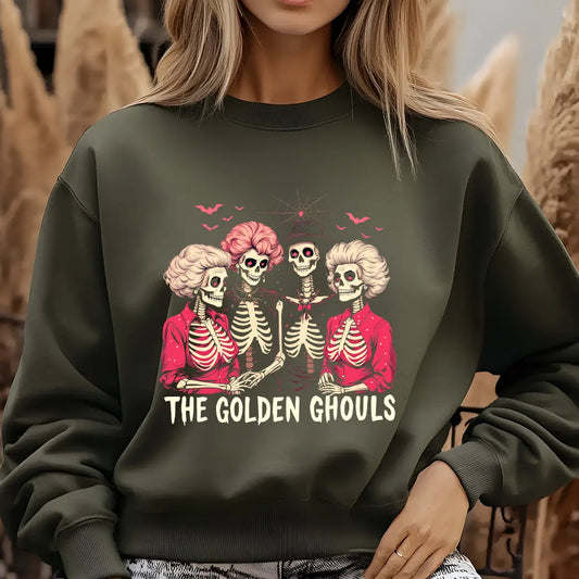 Green sweatshirt with three skeleton women in vintage hairstyles and red outfits, with the text “The Golden Ghouls” in cream lettering.