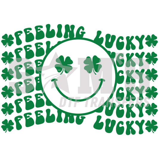 St. Patrick's Day themed DTF design featuring a circle of 'FEELING LUCKY' text with a smiling face and shamrocks in vibrant green.