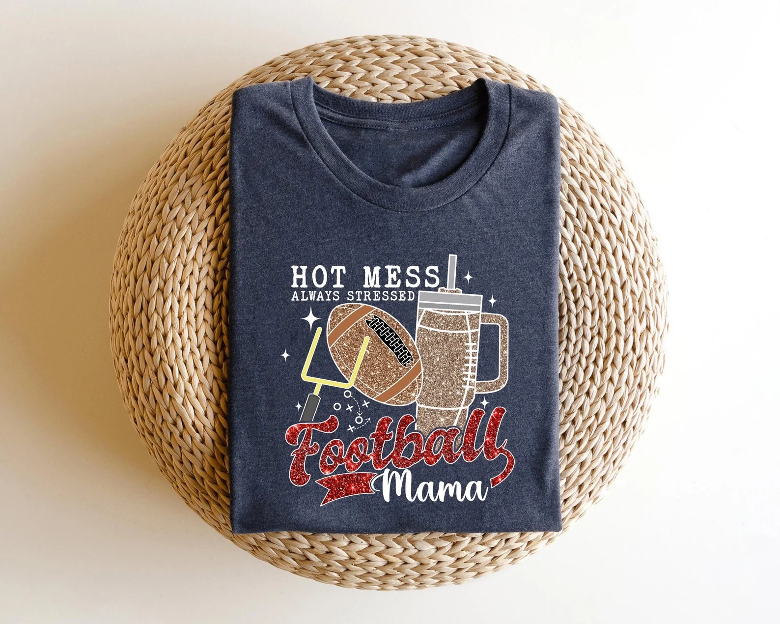 Football Mama Hot Mess DTF Transfer on a navy t-shirt featuring football elements and glittery drink graphics.