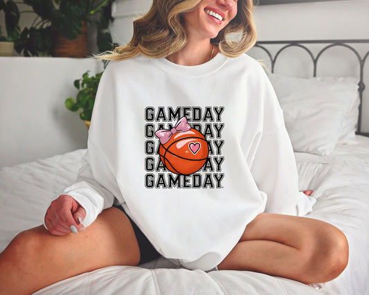 Gameday Basketball Bow DTF Transfer on a white sweatshirt featuring repeating "Gameday" text and a basketball with a pink bow.