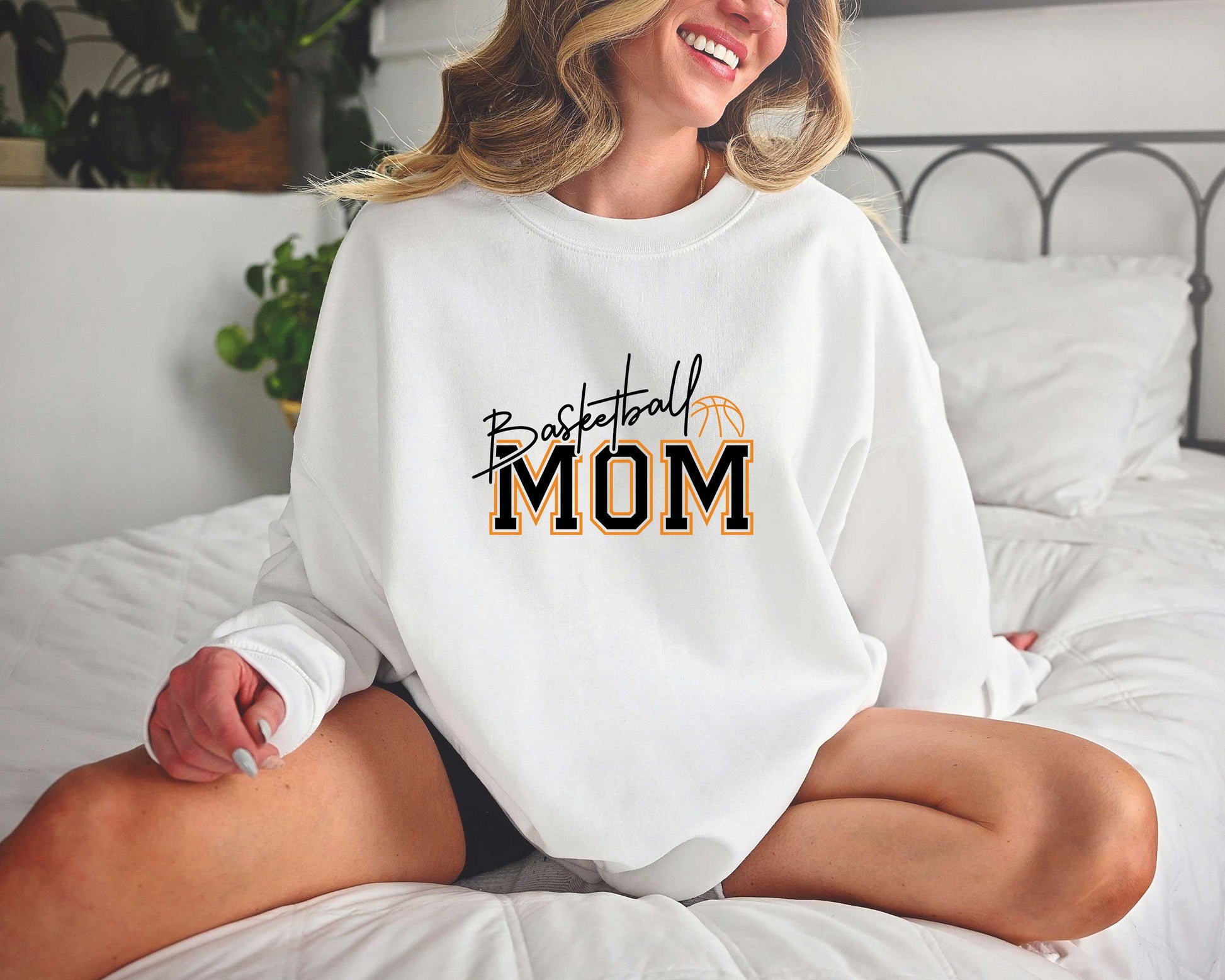 Basketball Mom Loud & Proud DTF Transfer on a white sweatshirt featuring bold text and a basketball heart graphic.