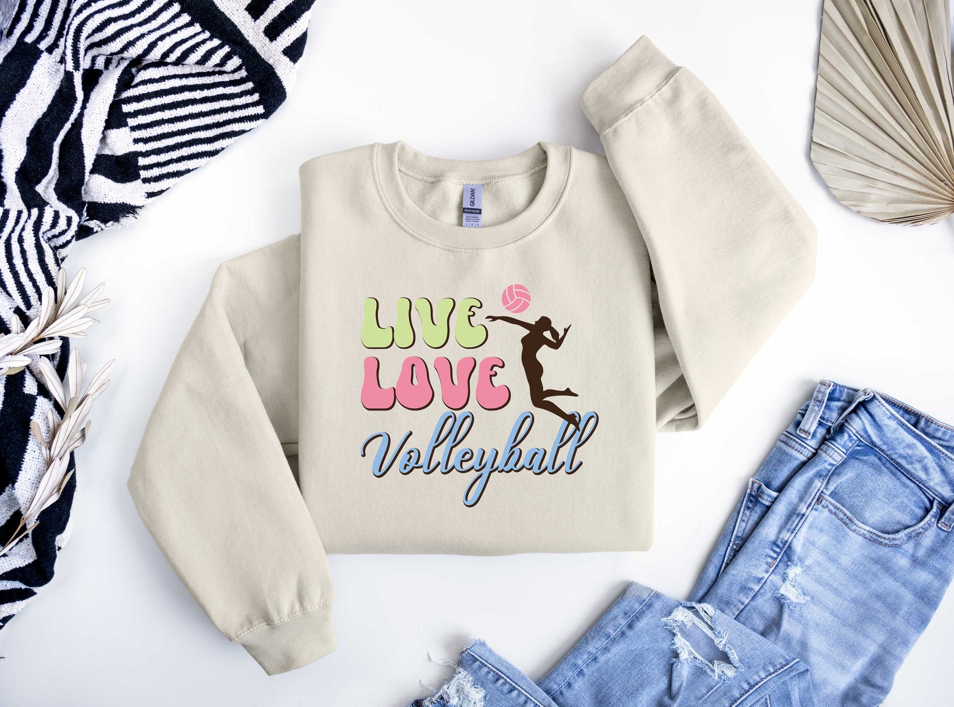 Live Love Volleyball DTF transfer design with pastel text and a volleyball player silhouette on a beige sweatshirt.