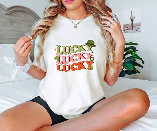 Retro-style St. Patrick’s Day ready-to-press DTF transfer with stacked "LUCKY" text, shamrocks, and a leprechaun hat