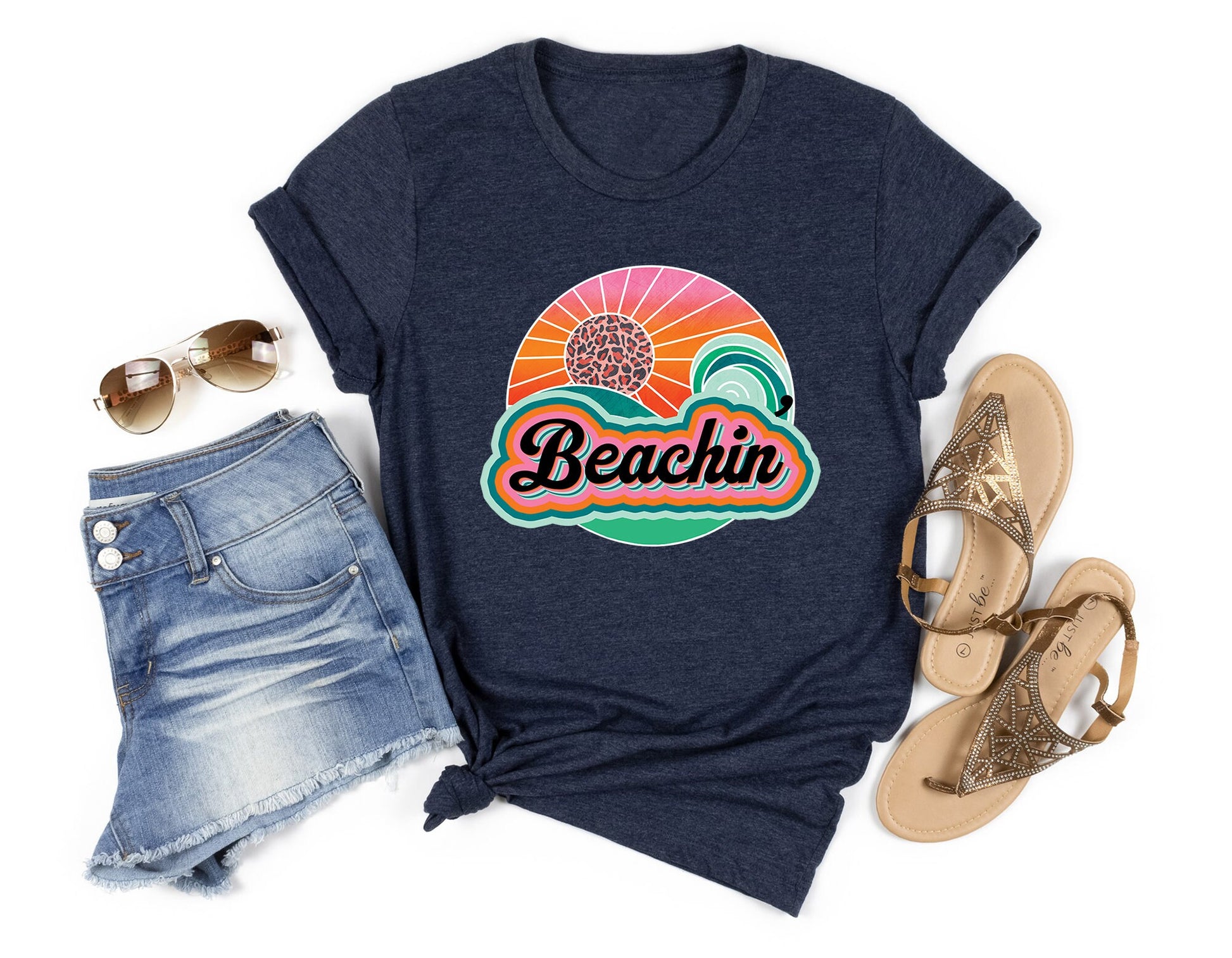 Beachin' Summer DTF Transfer with sunset and ocean design on a navy T-shirt.