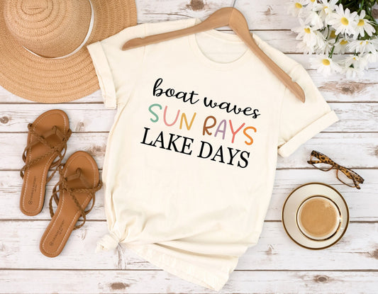 Boat Waves Sun Rays Lake Days DTF Transfer on a cream T-shirt with summer accessories.