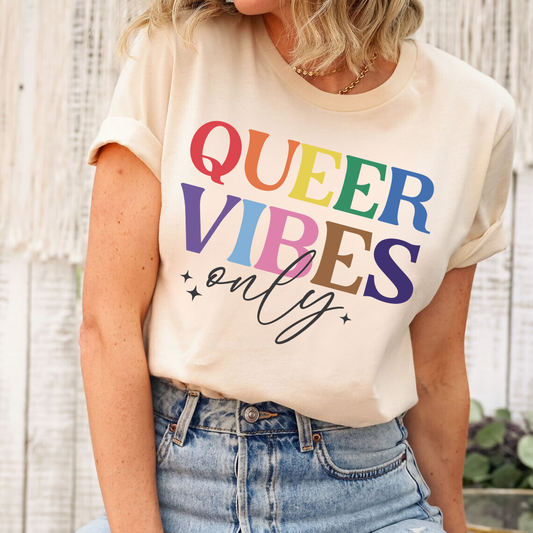 Queer Vibes Only DTF Transfer design with rainbow text on a cream T-shirt worn by a woman.