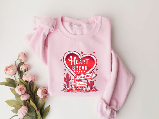 Heartbreak Motel Valentine's Day DTF Transfer design on a pink sweatshirt with floral accents.

