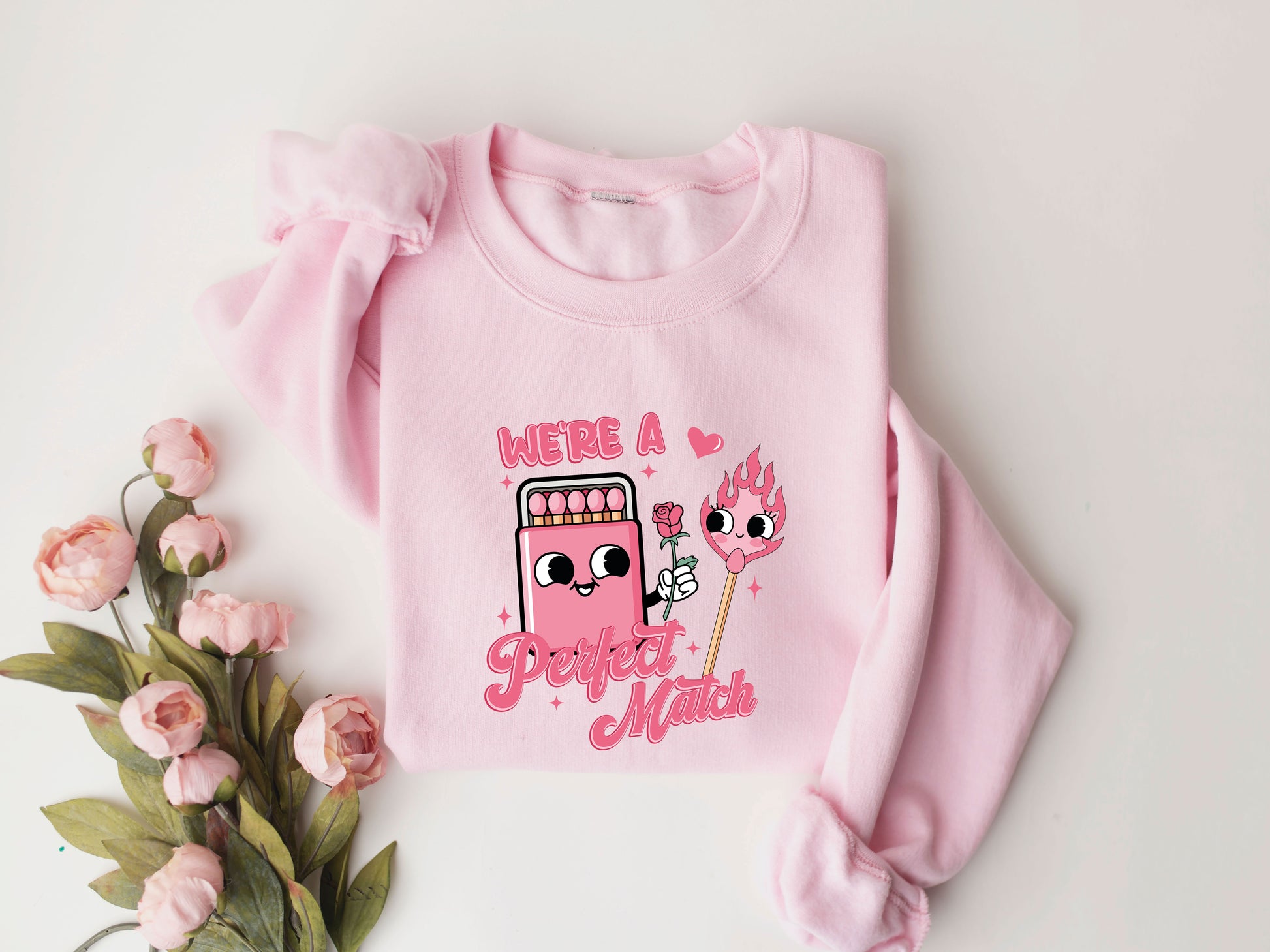 We're a Perfect Match Valentine's Day DTF Transfer design on a pink sweatshirt with floral